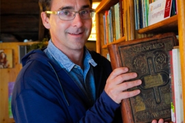 Crispin Clarke ’98 holds his volume of Shakespeare's works